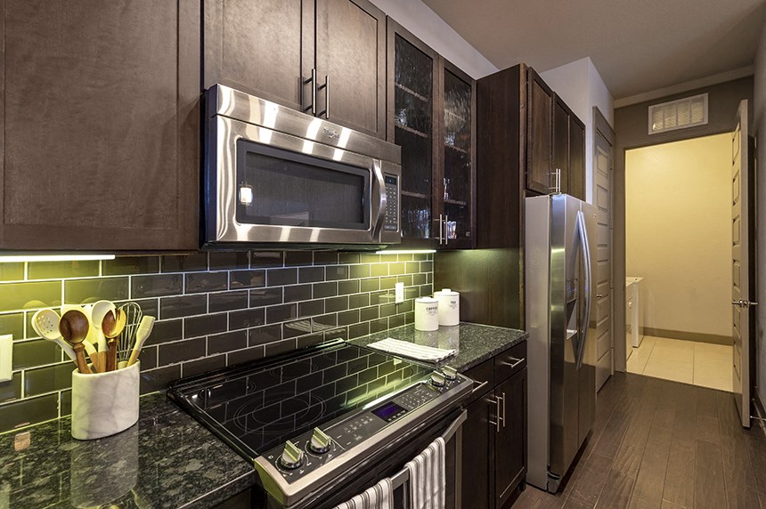 a kitchen with stainless steel appliances and black counter tops