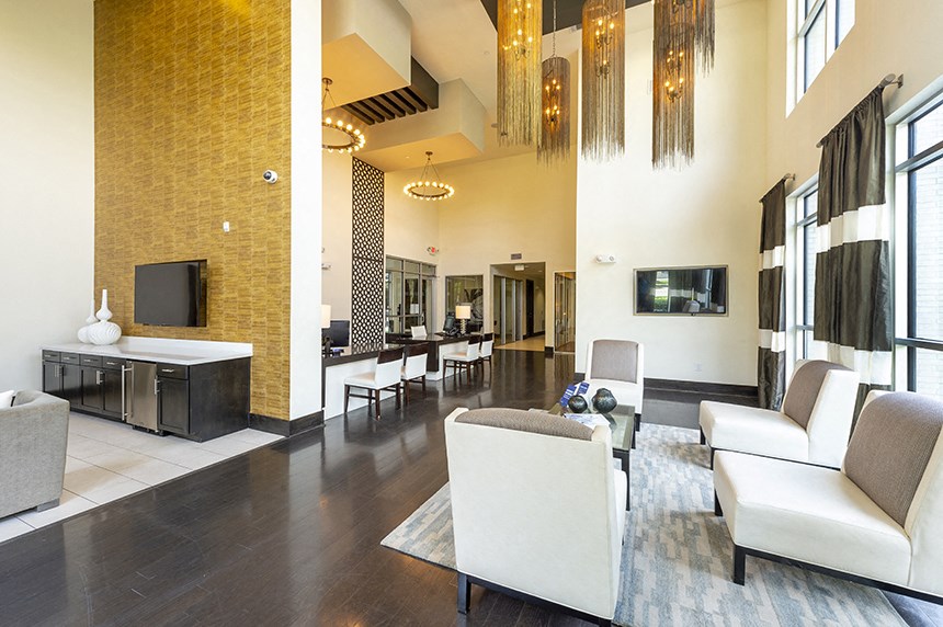 a view of the lobby of a hotel with couches and chairs