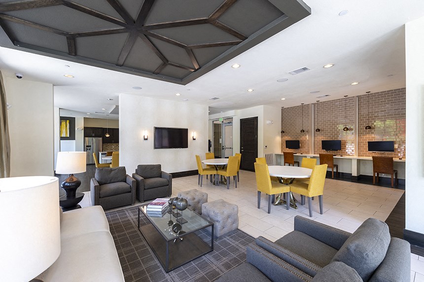 the living room and dining room in the clubhouse at the preserve at polo towers