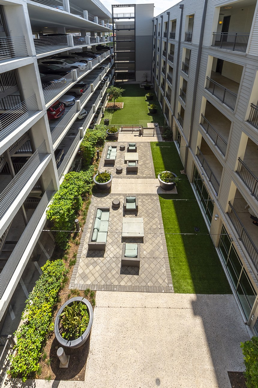 an aerial view of the courtyard of an apartment building