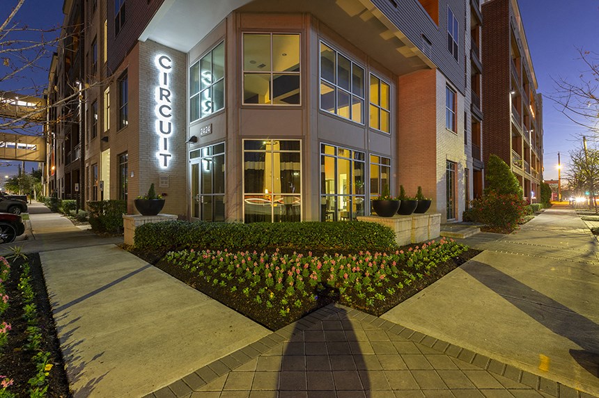 a city street with a building with a sign on the side of it