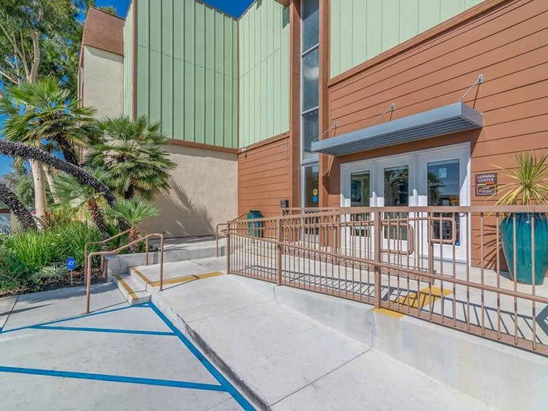 the front of a building with steps and a fence at Citrus Court Apartments, Whittier, 90606