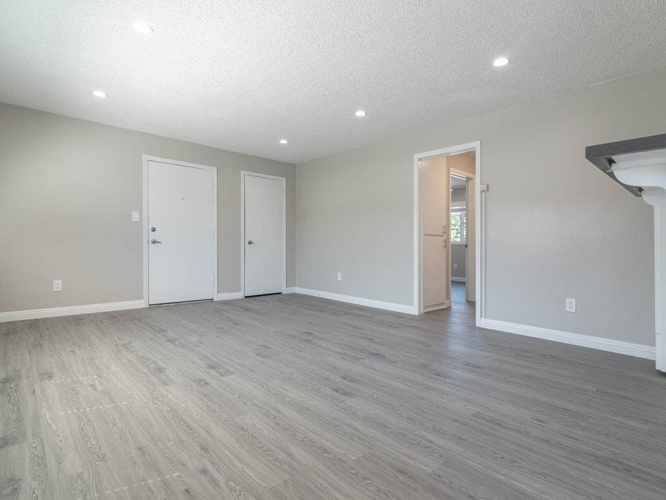 the spacious living room is open to the dining room and kitchen at Citrus Court Apartments, Whittier