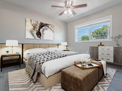 a bedroom with a bed and a ceiling fan at Citrus Court Apartments, Whittier