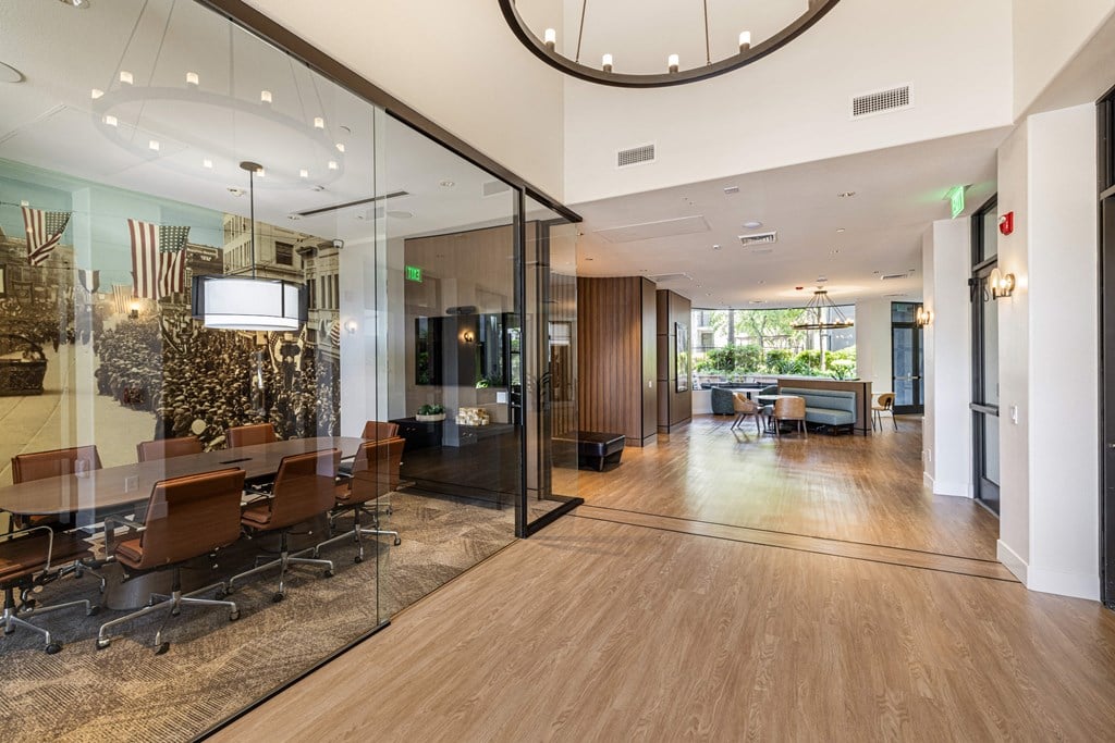 a conference room with glass walls and a table and chairs