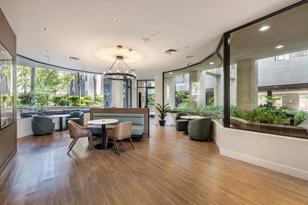 a large room with tables and chairs and large windows