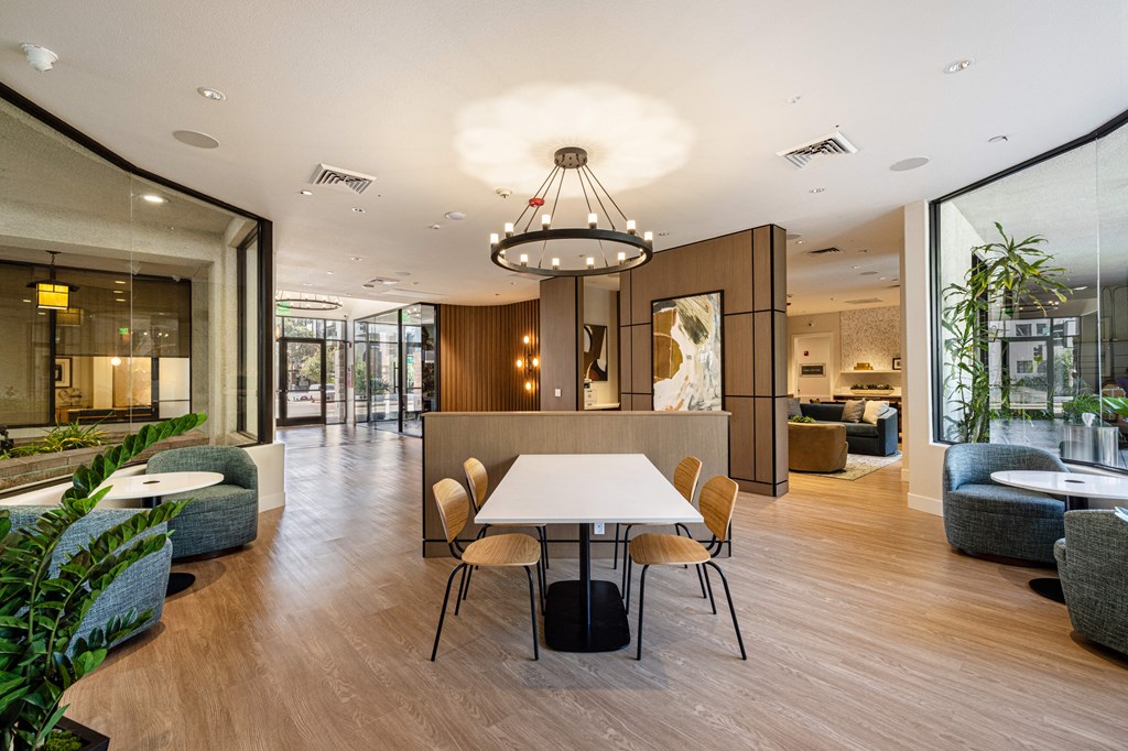 a large dining room with a white table and chairs
