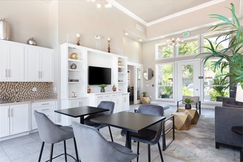 A modern kitchen with a dining table and chairs.