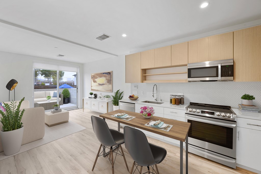 A modern kitchen with a dining table and chairs.