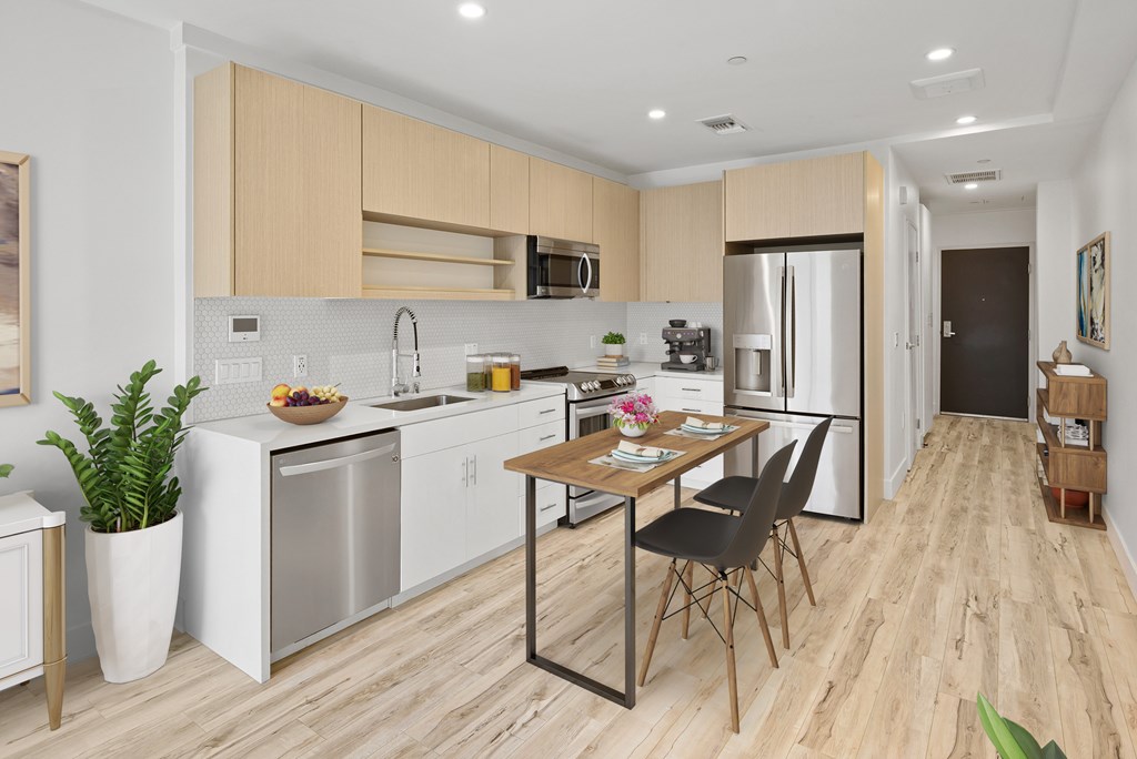 A modern kitchen with a dining table and chairs.