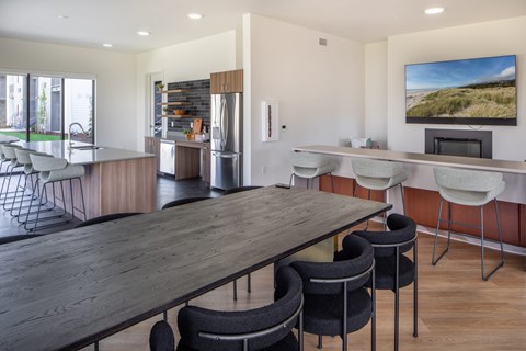 Modern kitchen with a long wooden table and chairs at The Arvon, Vancouver, WA 98662