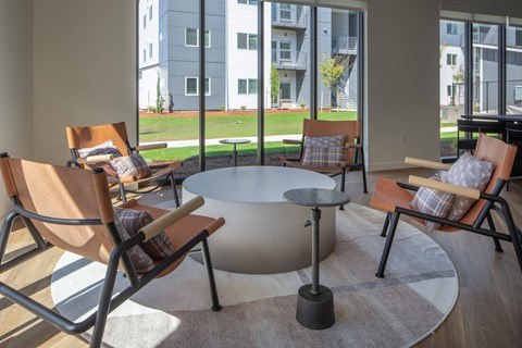 Modern living room with a large window and a view of a building at The Arvon, Vancouver