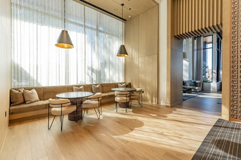 A modern living room with a round table and chairs.