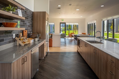 A modern kitchen with wooden cabinets and a large island.