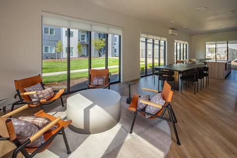 A modern living room with a large table and chairs.
