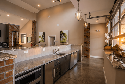 A modern kitchen with dark wood cabinets and a granite countertop.