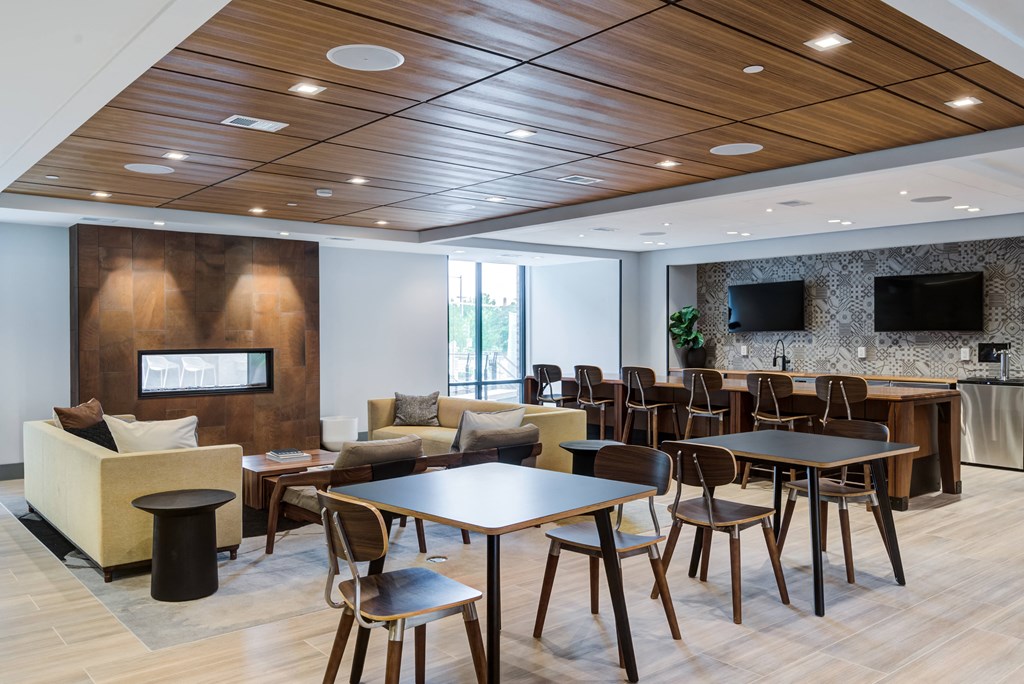 a dining room with tables and chairs and a fireplace