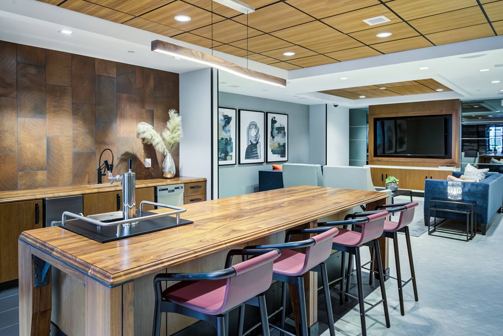 a long communal table in a room with chairs and a television