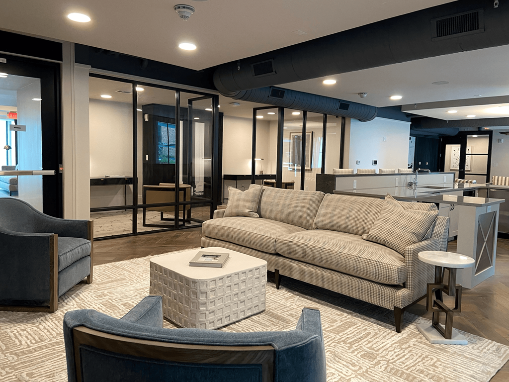 a lobby with a couch and chairs and a coffee table