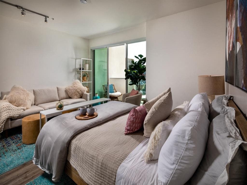 a bedroom with a bed and a couch