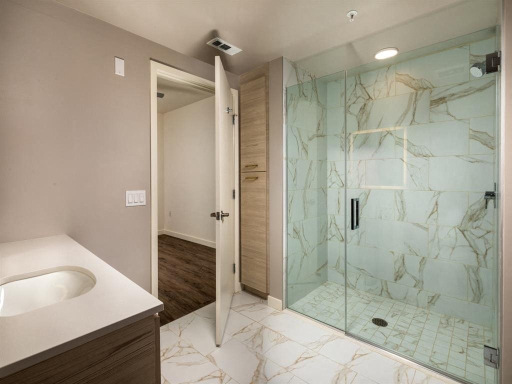 a bathroom with a shower and a sink