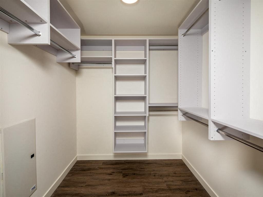 a large walk in closet with shelves and