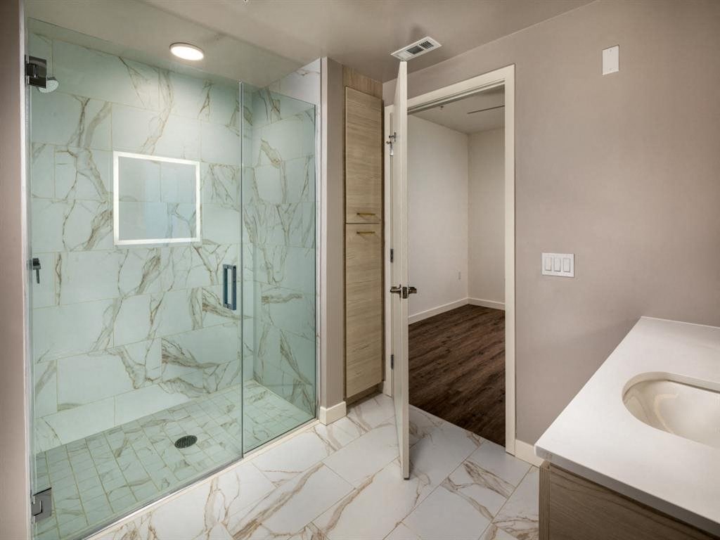 a bathroom with a shower and a sink