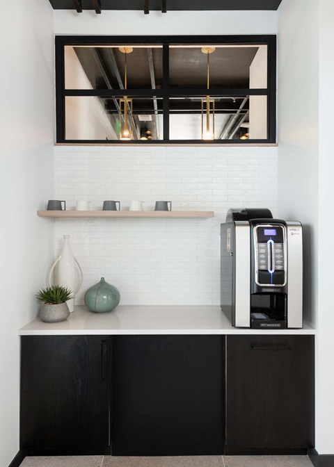 a white kitchen with a microwave and a window