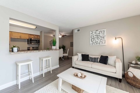 A living room with a white couch and a coffee table.