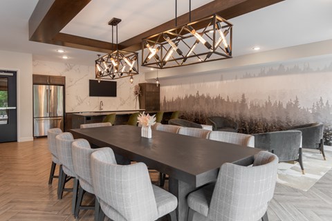 A modern dining room with a large table and chairs.