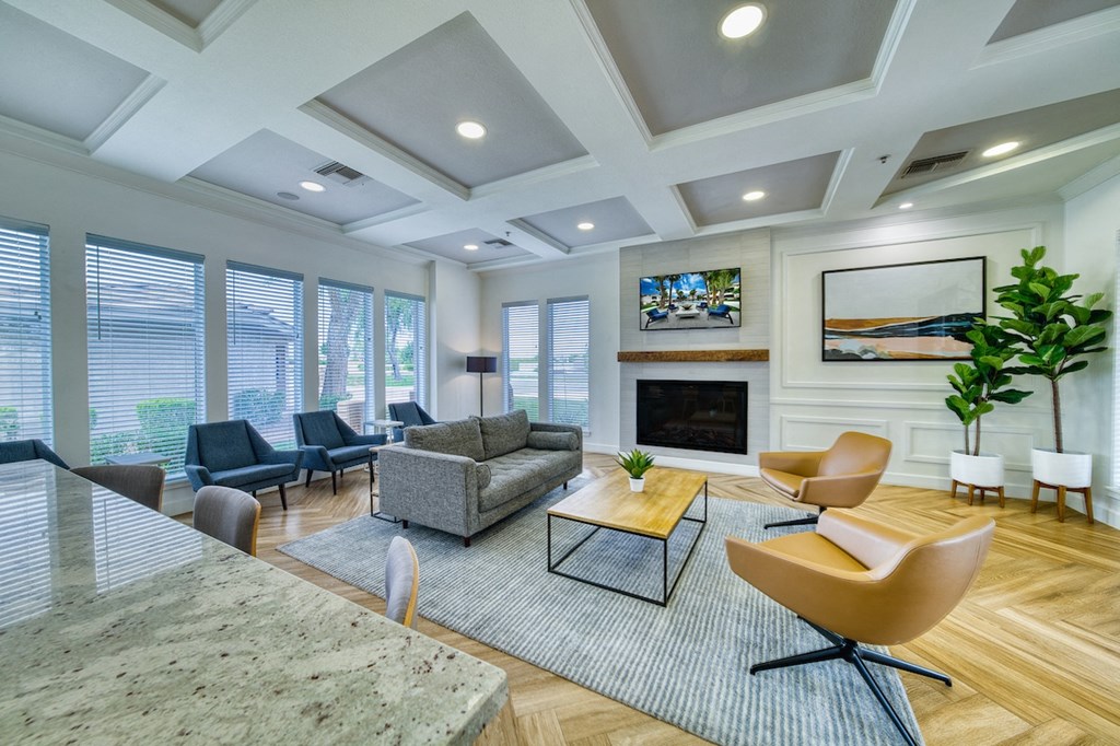 A living room with a fireplace and a painting above it.