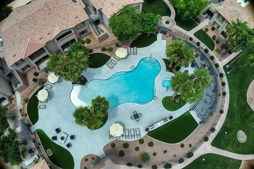 A large backyard with a pool and a patio area.