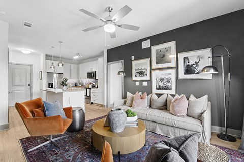 A living room with a white couch and a brown chair.