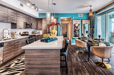a kitchen with a bar and a dining table with chairs