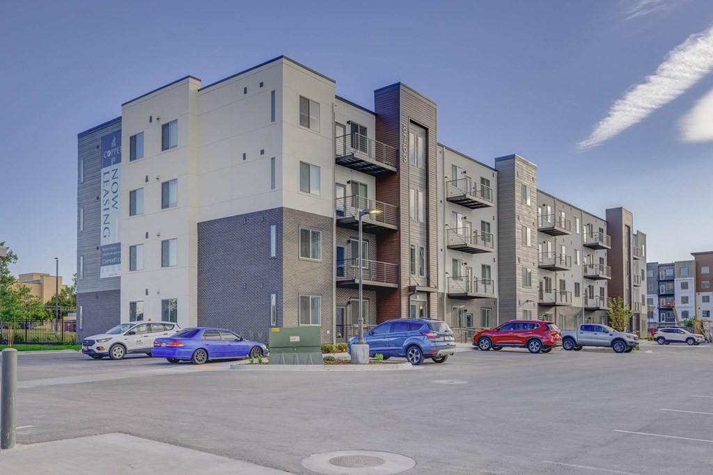 a picture of an apartment building with cars parked in front of it at Copper 87, West Jordan, 84088