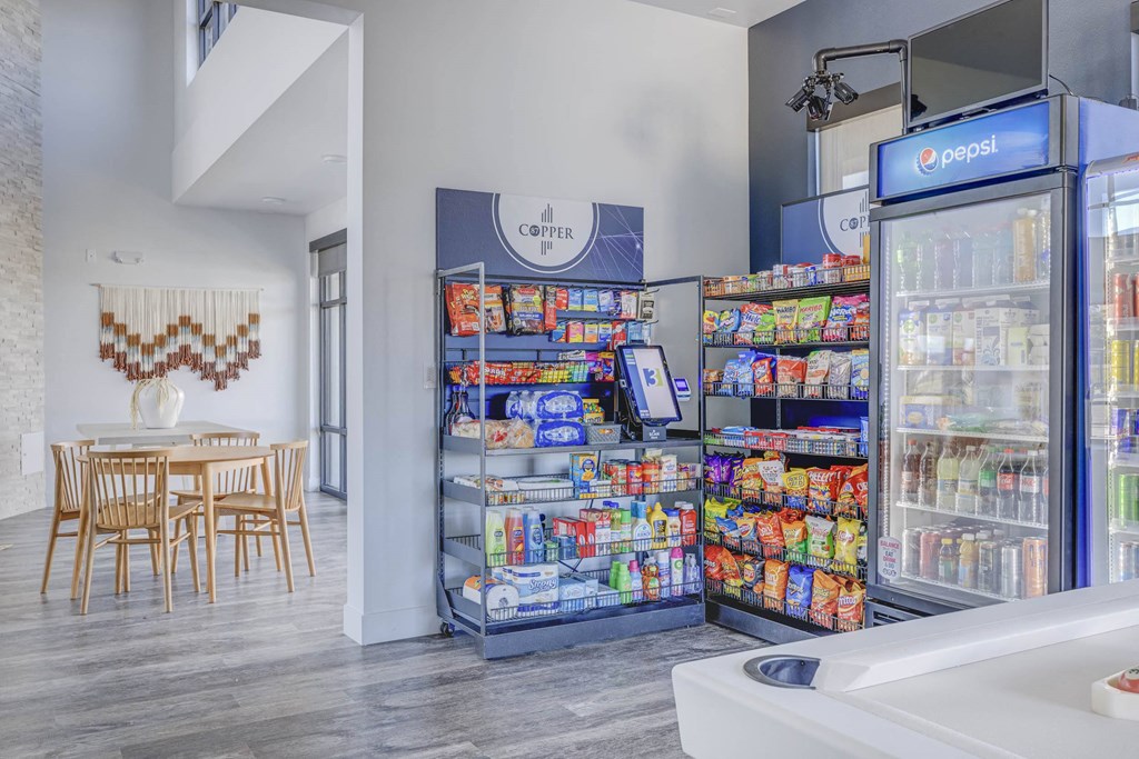 a pantry with two refrigerators and a table and chairs in the background at Copper 87, West Jordan
