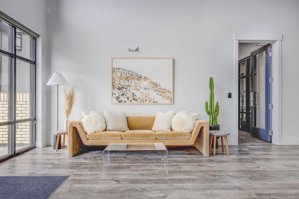 a living room with a couch and a cactus in front of a window at Copper 87, West Jordan Utah