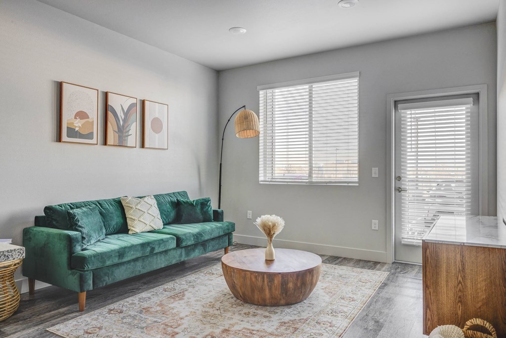 a living room with a green couch and a coffee table