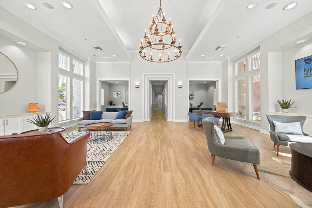 a living room with furniture and a chandelier