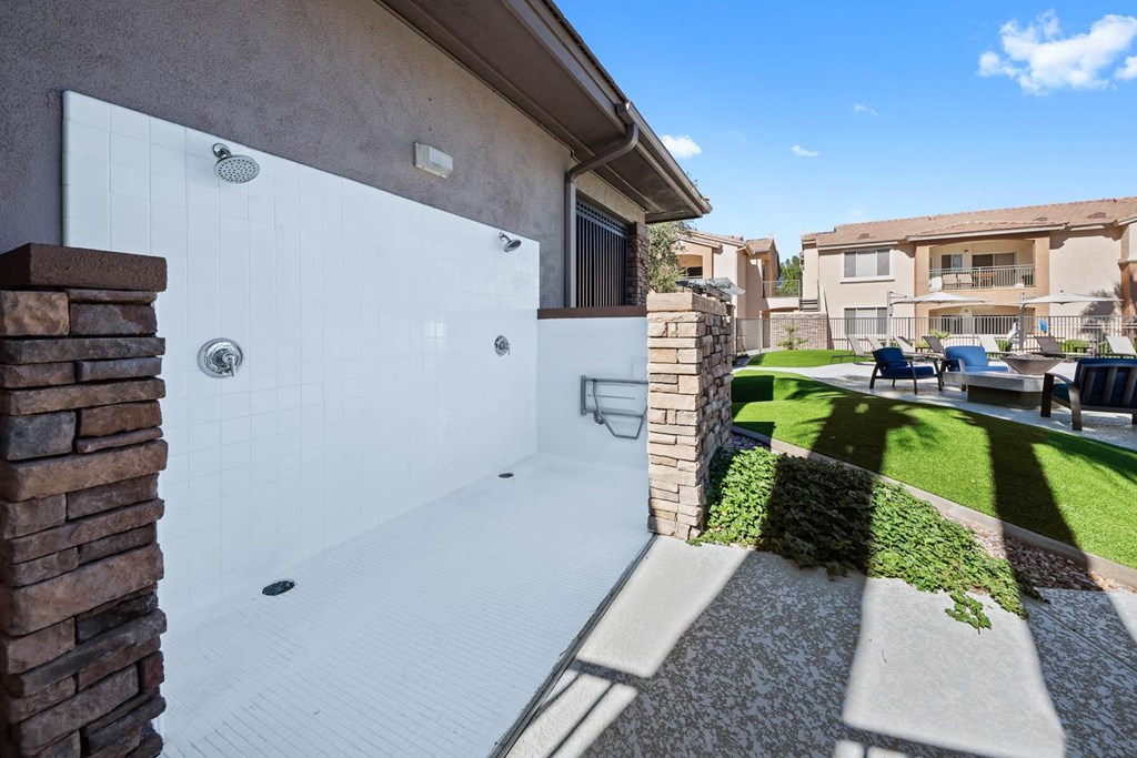 a backyard with a patio and a white fence