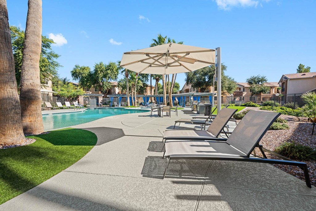 a group of lounge chairs sitting next to a swimming pool