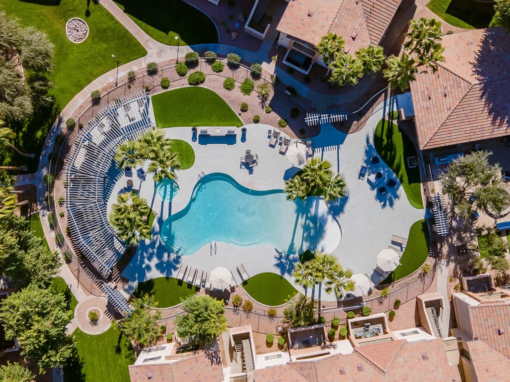 an aerial view of a swimming pool with a resort style pool