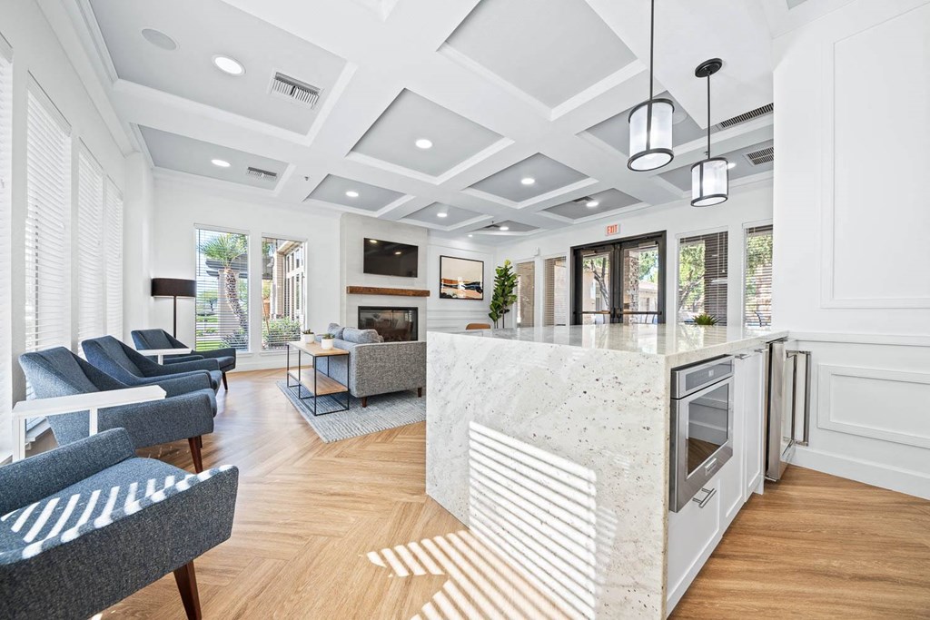 a living room with a kitchen and a fireplace