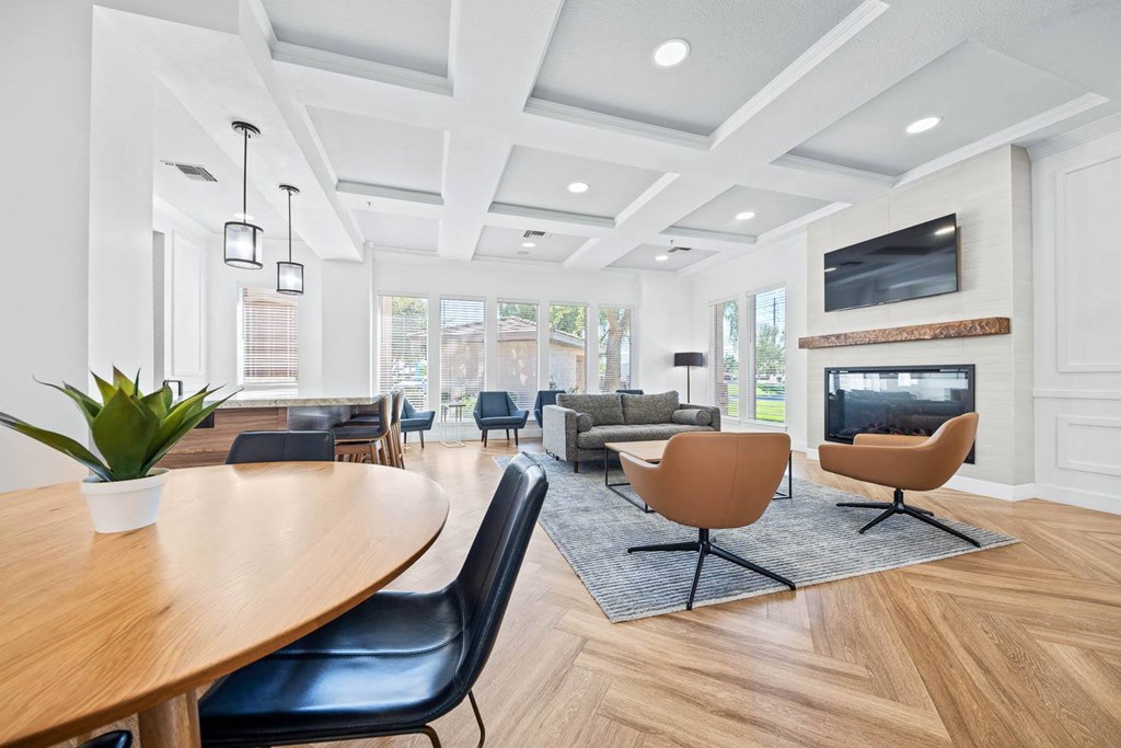 a living room with a fireplace and a table and chairs