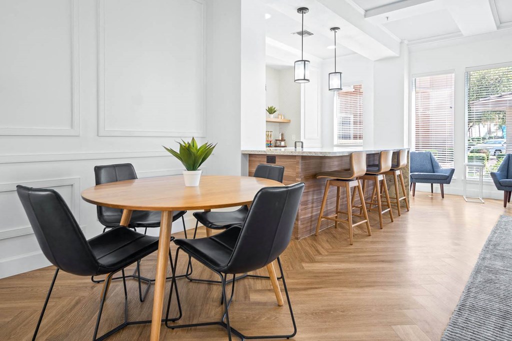a dining room with a table and chairs