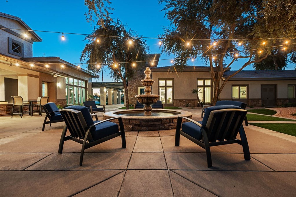 a patio with chairs and a fountain