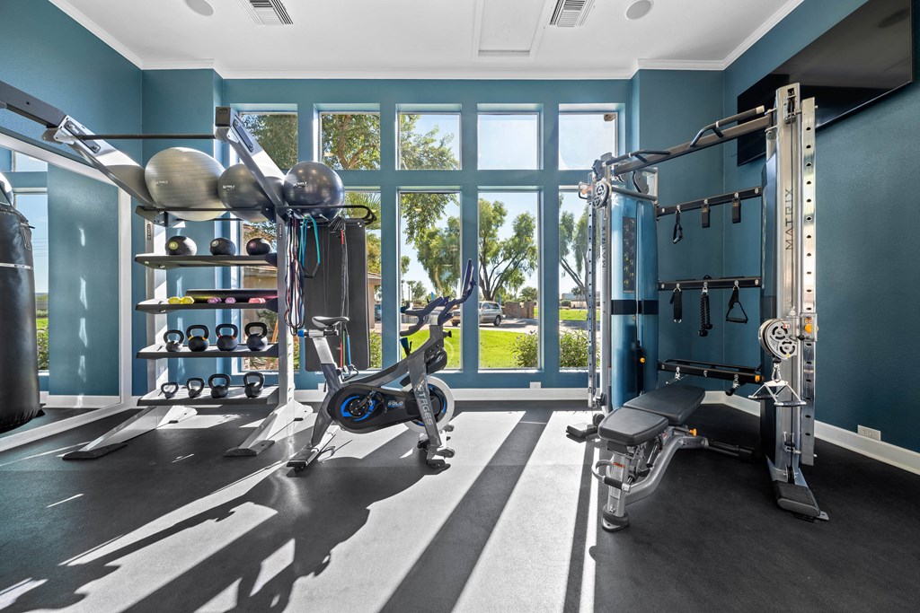 a home gym with exercise equipment and a window