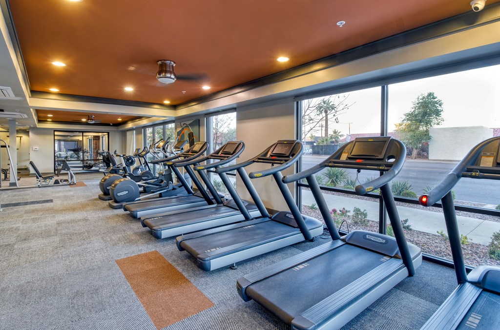 A gym with treadmills and other equipment.
