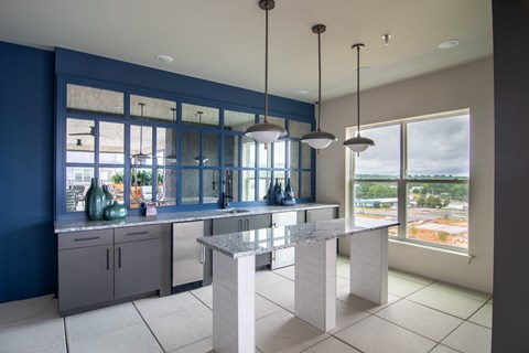 a kitchen with blue and white counter tops and a window