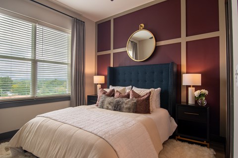 a bedroom with purple walls and a white bed